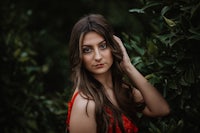 a young woman in a red dress is posing for a photo